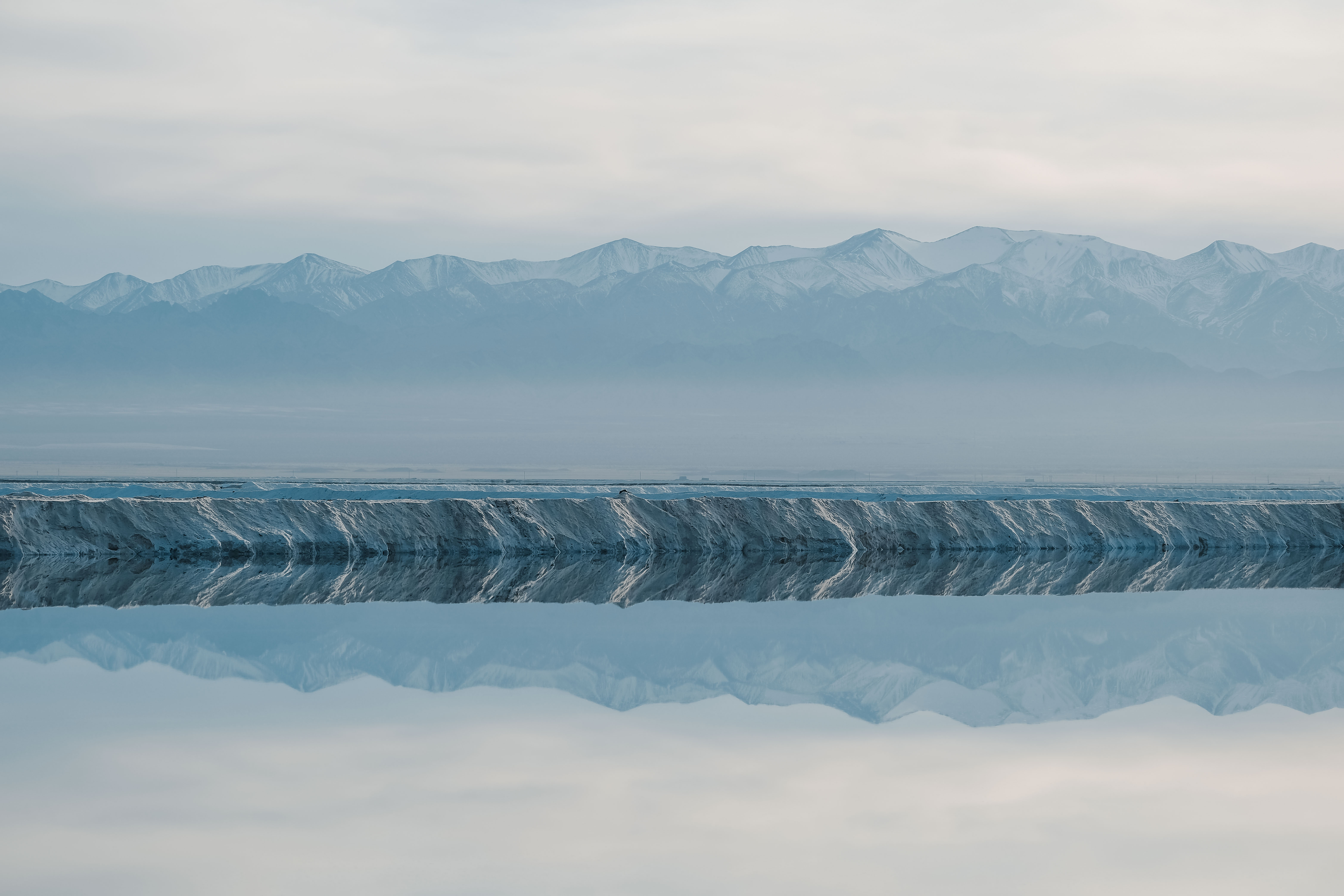 Mountain reflections across a still salt lake