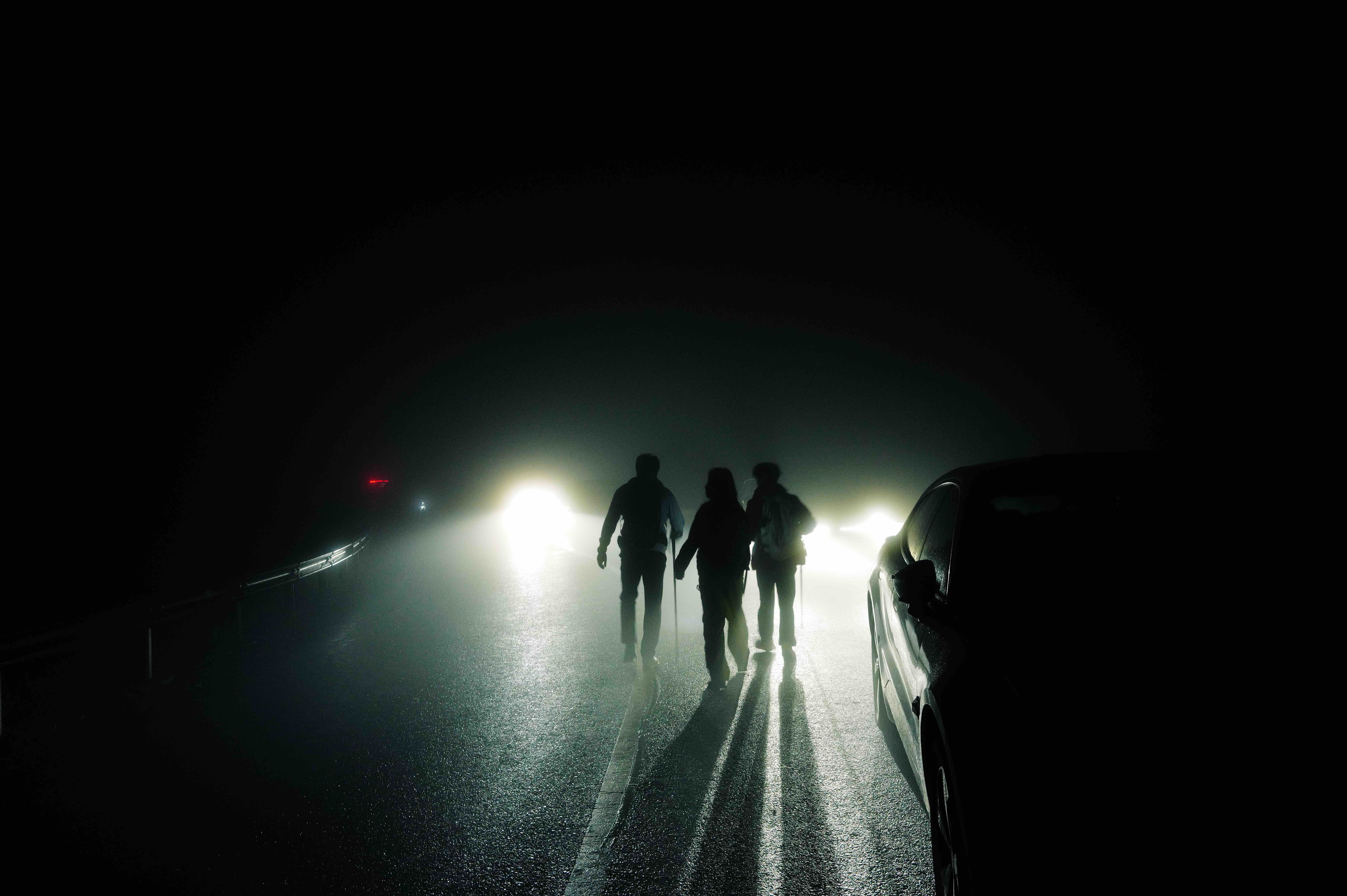 People and vehicles in dense fog