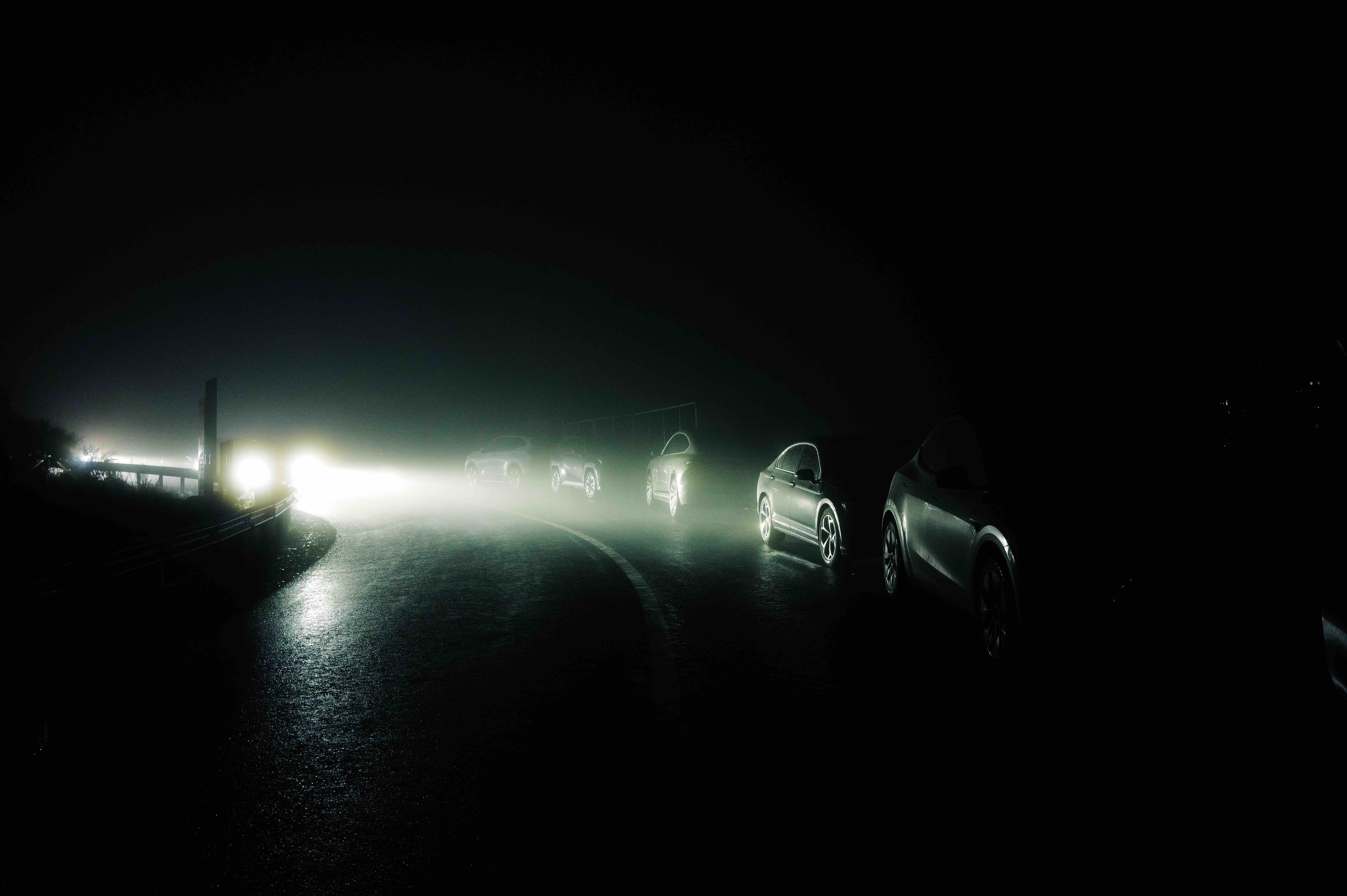 Headlights around a bend in the fog